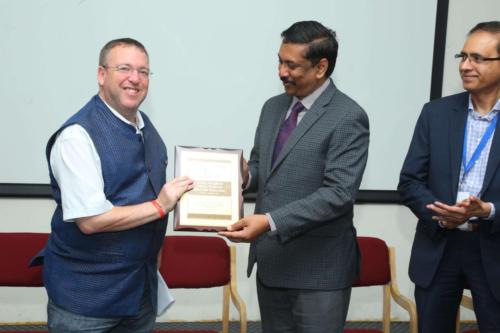 Dr Sreenivasa Raju Kalidindi & Dr Sridhar Redla presenting a Memento to Dr Andrew Fleming, British Deputy High Commissioner at the Global Fellowship Induction Programme held in August 2019 at Apollo Health City, Hyderabad.